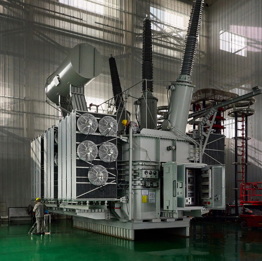 Substation power transformer with cooling fans inside manufacturing plant